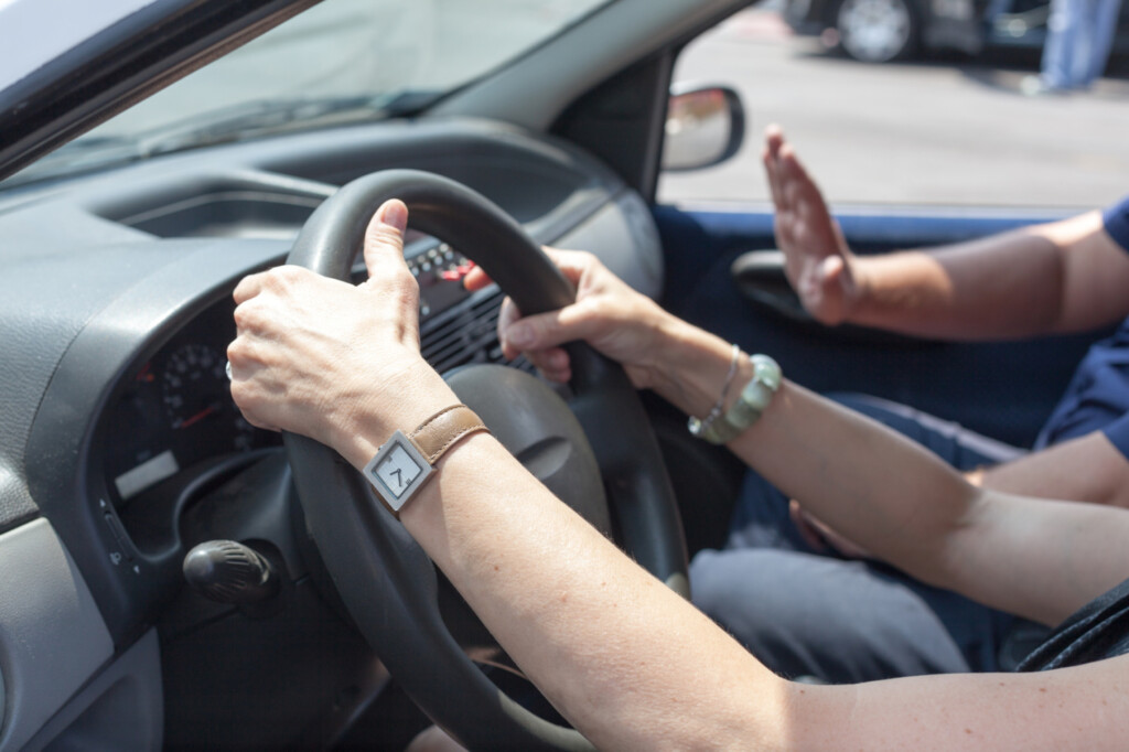 Senior Learning To Drive A Car With A Driving Instructor